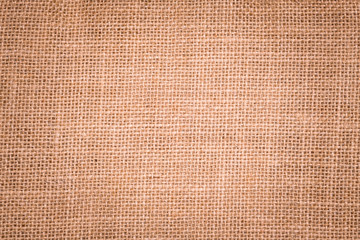 Rough hessian background with flecks of varying colors of beige and brown. with copy space. office desk concept, Hessian sackcloth burlap woven texture background.