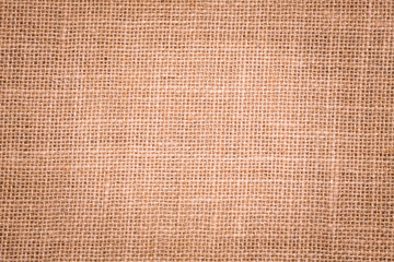 Rough hessian background with flecks of varying colors of beige and brown. with copy space. office desk concept, Hessian sackcloth burlap woven texture background.