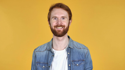Smiling Redhead Man Isolated on Yellow Background