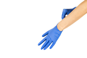 A woman dresses medical protective gloves on her hands. Concept of protection against infections...