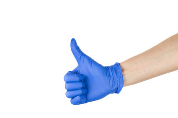 A woman 's hand in a silicone medical glove with her thumb raised up. A finger figure marking 