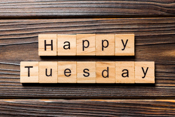 Happy Tuesday word written on wood block. Happy Tuesday text on wooden table for your desing, concept