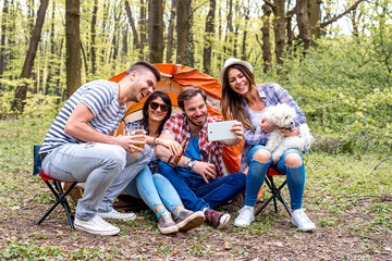 Fototapeta premium Friends taking a selfie while camping together