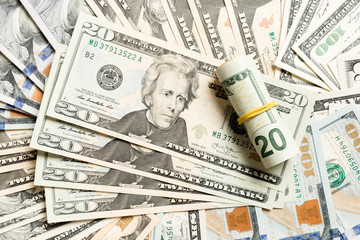 Close up of 20 dollar bills pile on background made with different dollar banknotes. Top view of financial concept