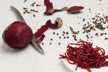 Fermented beets on plate. Beets and knife. Peeling vegetables.