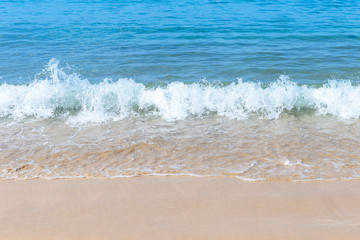 Fototapeta na wymiar Clean white wave on clean sand beach, summer outdoor day light, nature background