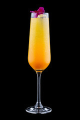 Exquisite cold cocktail with champagne and orange juice on a dark background