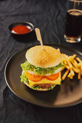 Unhealthy concept. unhealthy food: Burger, sauce, potatoes, cola.