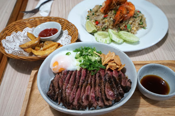 Wagyu beef rice served with stir fry shrimp rice and fried potato wedge
