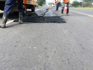 Workers repairing pavement in Asia, blurred images