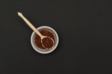 loose rooibos tea in a serving wooden spoon