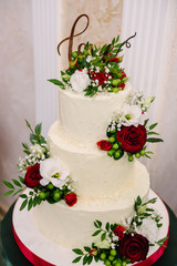 white cream cake decorated with roses and the inscription love