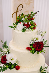 white cream cake decorated with roses and the inscription love