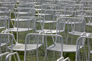Empty white metal garden chair in many rows due to cancelled outdoor event