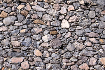 Texture of a grey granite stone wall for background