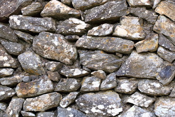 Texture of a grey granite stone wall for background