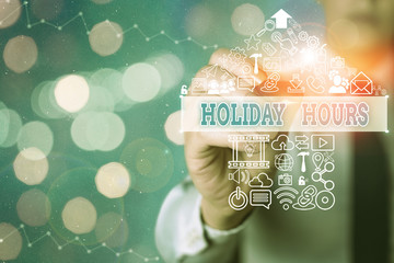 Conceptual hand writing showing Holiday Hours. Concept meaning Overtime work on for employees under...