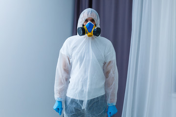 Man in protective suit, a mask and a respirator.