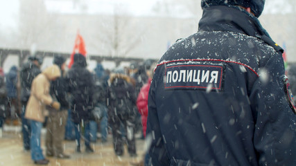 Police at a rally under snowfall