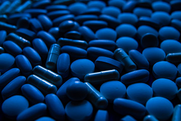 Blue white pills, tablets capsule. Color of the year concept.