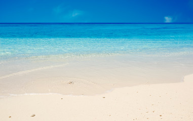 Ocean sand beach and blue sky as summer vacation concept