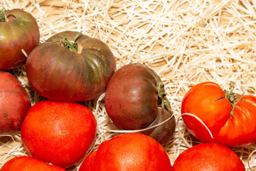 Fresh tomatoes on straw at a market
