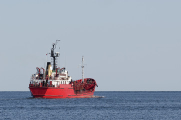 OIL PRODUCTS TANKER - The red ship at sea sails with a fuel load