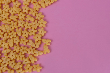 Breakfast cereal on a pink background. Top view, copy space.