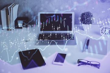 Forex market graph hologram and personal computer on background. Double exposure. Concept of...
