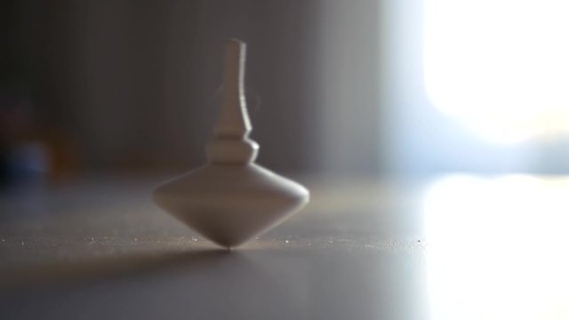 A wooden spinning bobber is losing balance. HD, 1920x1080, slow motion