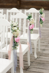 decorated chairs on wedding ceremony