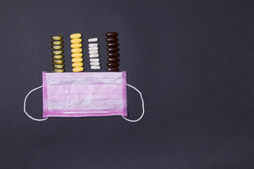 White medical face mask and tablets. Medicine and healthcare. on black background with copyspace
