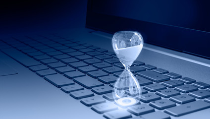 Close-up of white hourglass on laptop keyword
