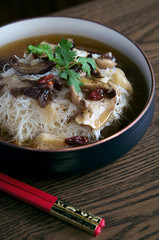 Fusion asian noodle soup with mushrooms in bowl