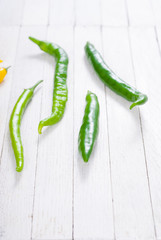 chili peppers selection on white wood table background