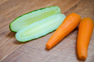 Cucumber and carrots. Great Christian Lent. vitamins during quarantine. Proper nutrition. Diet with vegetables. Easter holiday. Healthy food, healthy eating for breakfast. Wood background