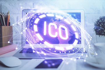 Multi exposure of blockchain and crypto economy theme hologram and table with computer background....