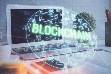 Multi exposure of blockchain and crypto economy theme hologram and table with computer background....