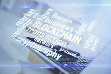 Multi exposure of blockchain and crypto economy theme hologram and table with computer background....