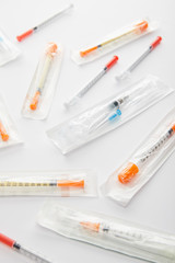 Selective focus of syringes on white background