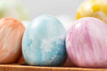  Colorful Easter eggs on a wooden stand.Close-up.