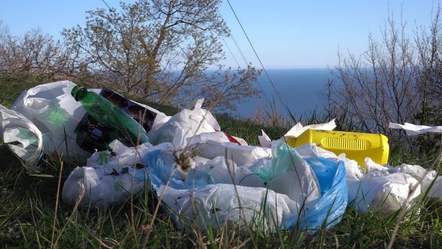 A pile of discarded used baby diapers in nature. Personal hygiene, bathroom waste. Environmental Impact of Disposable Nappies. Plastic pollution of nature. Soil, water and air pollution