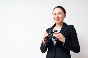 Conceptual shot of businesswoman with big binoculars