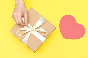 Cardboard box with ribbon and paper heart