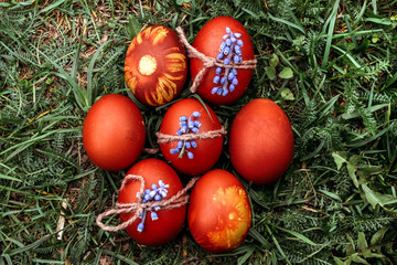 Easter background, multi-colored chicken and quail eggs on bright natural grass background.