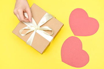 Two paper hearts and a gift box