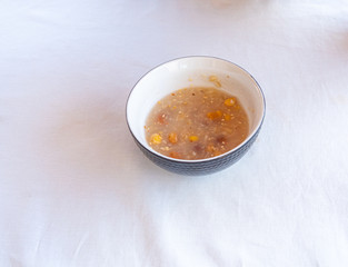 Traditional Turkish dessert ashure or Noah's Pudding with spoon on the table.