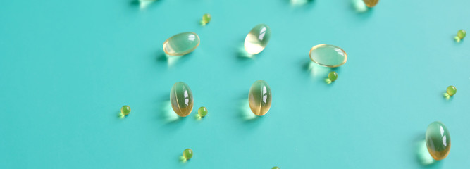 Fish oil capsules on a blue background. Omega-3