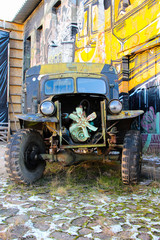 Steampunk bizarre auto with open engine. Creepy truck with rusted parts.