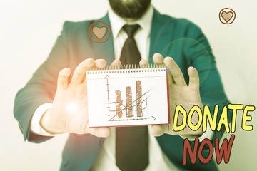 Handwriting text writing Donate Now. Conceptual photo to give something like money or goods to a...